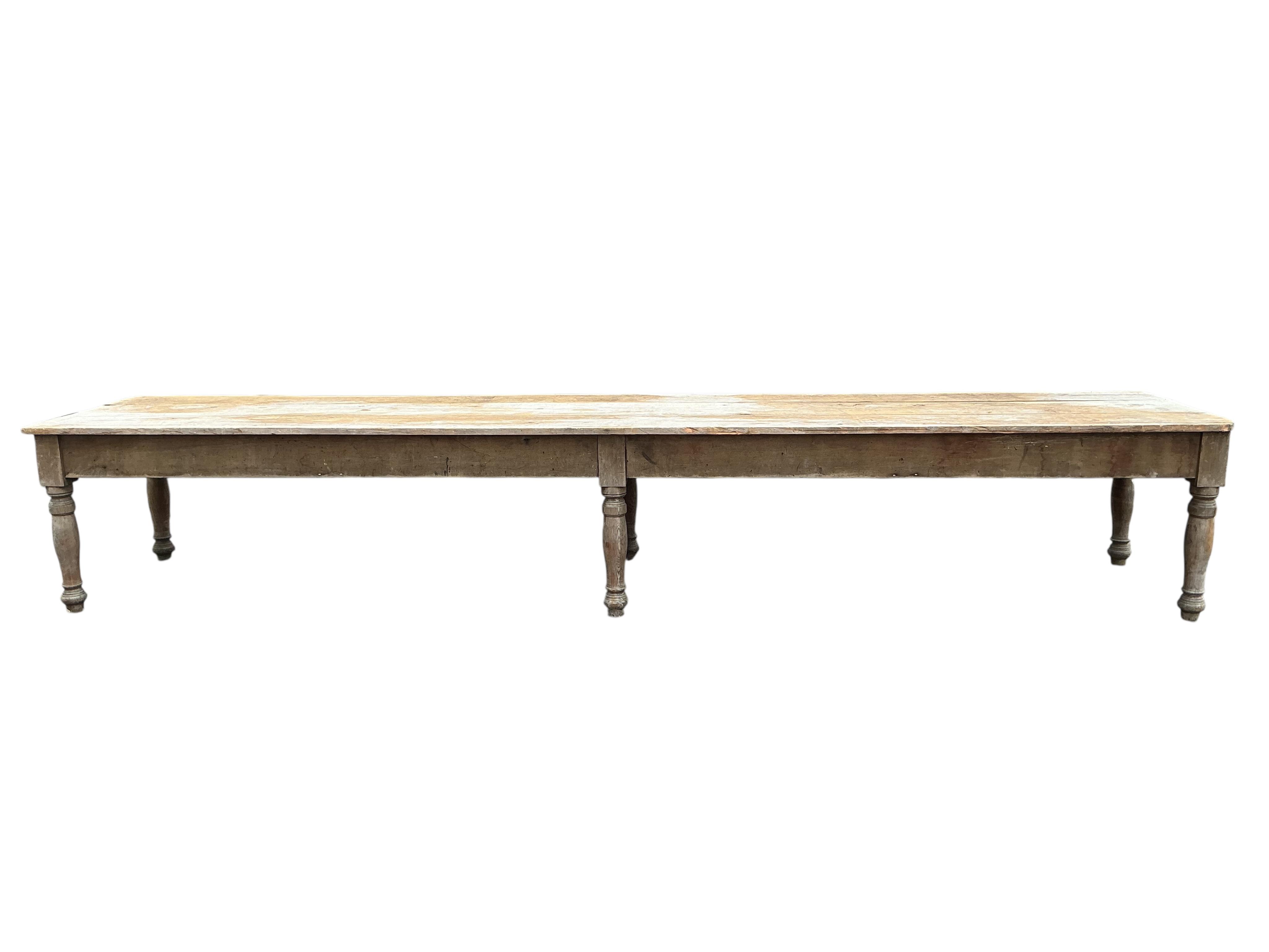 A long Victorian pine laundry table, length 600cm, width 104cm, height 86cm